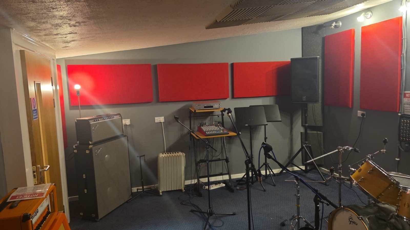 Another Smashroom rehearsal room filled with amplifiers, a mixing desk and microphone stands