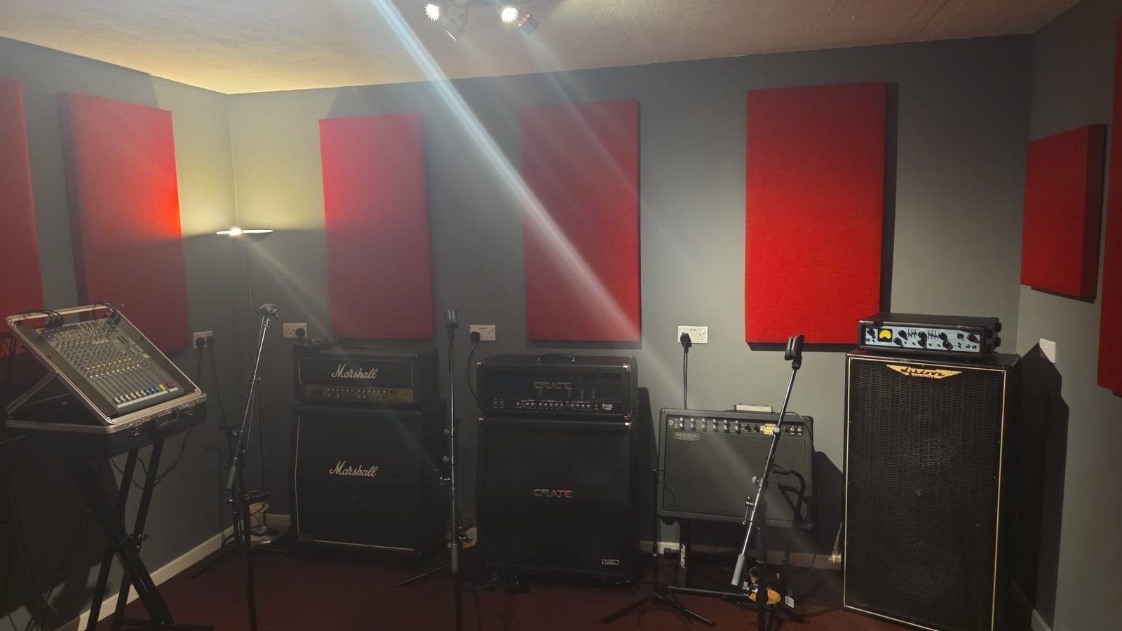 A Smashroom rehearsal room with red acoustic panels, Marshall amplifiers and monitors